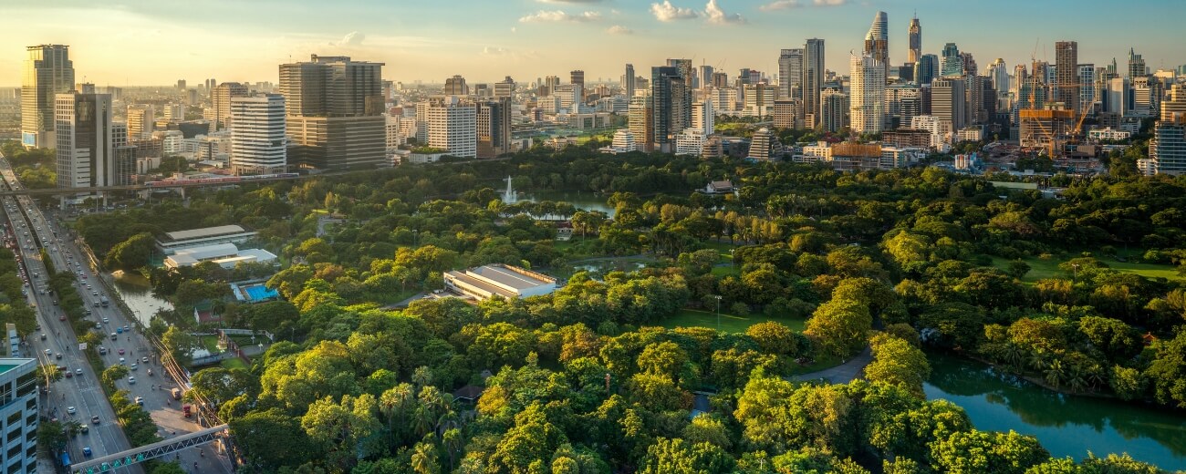 Bangkok skyline rising behind Lumpini Park, close to the central districts popular with British expats