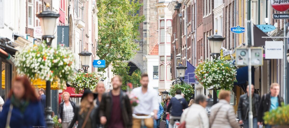 A vibrant European city street with people walking and cycling, representing the best cities to move to in Europe for UK expats A vibrant European city street with people walking and cycling, representing the best cities to move to in Europe for UK expats