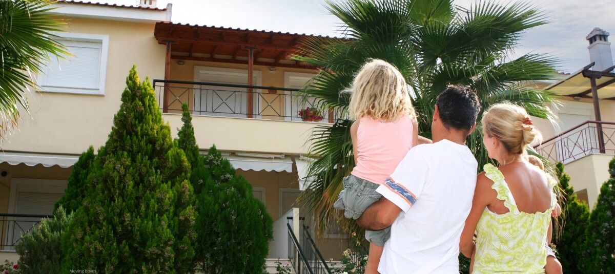 Family looking at Mediterranean home symbolising British expats moving to Spain or Portugal
