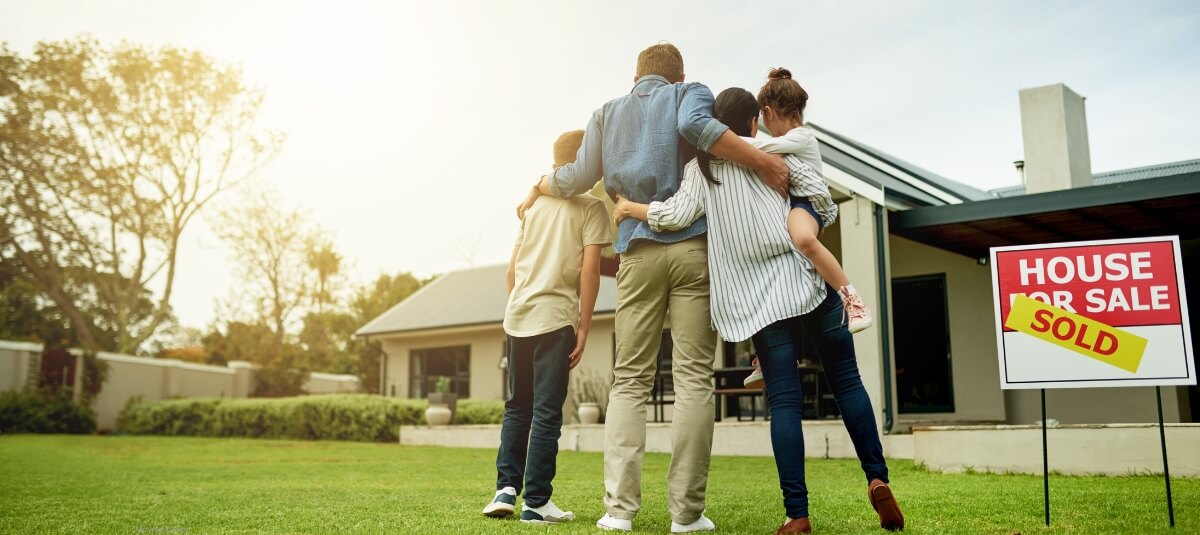 British family outside sold house preparing to relocate abroad
