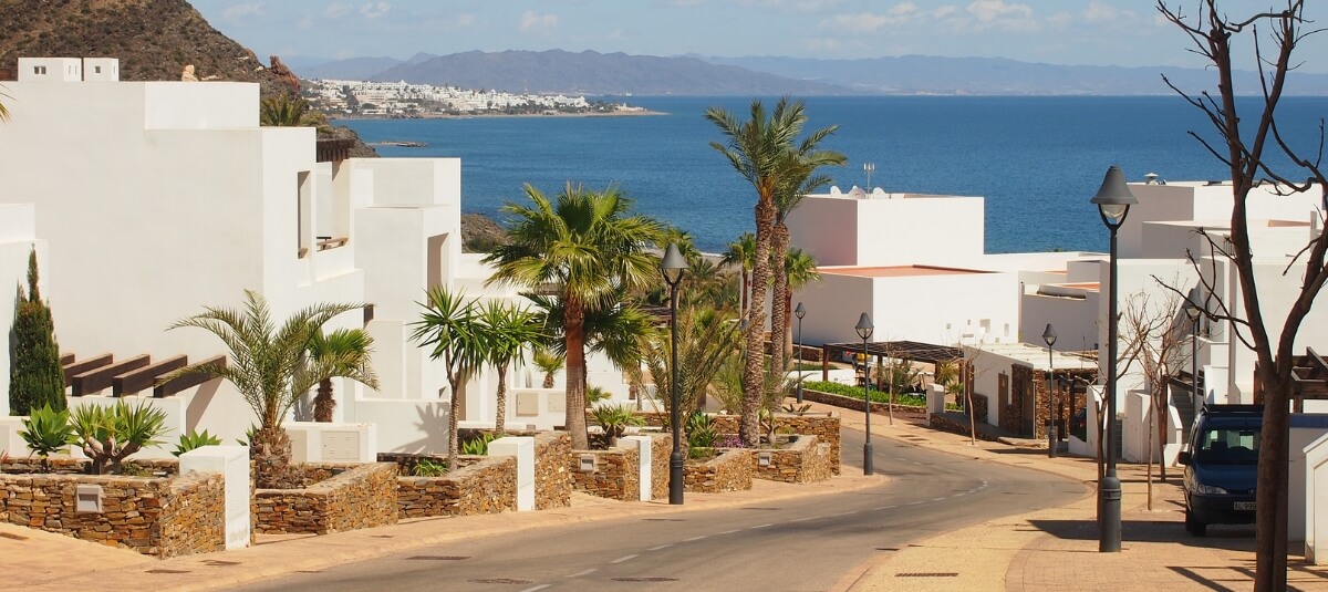 Modern Spanish coastal villas overlooking the sea, popular destination for Brits moving to Spain