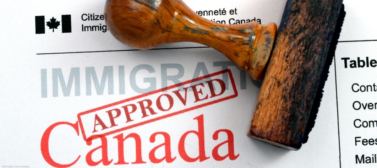 Close-up of a Canada immigration document stamped 'Approved,' symbolizing successful visa application and relocation process.