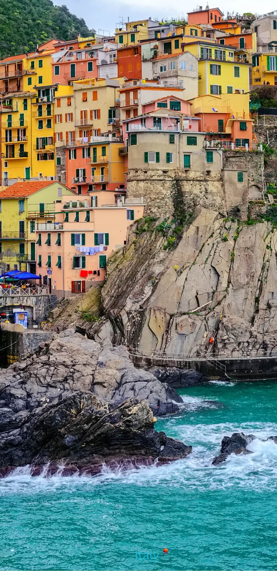 Colourful cliffside homes on the Italian coast, showing the lifestyle appeal of moving to Italy