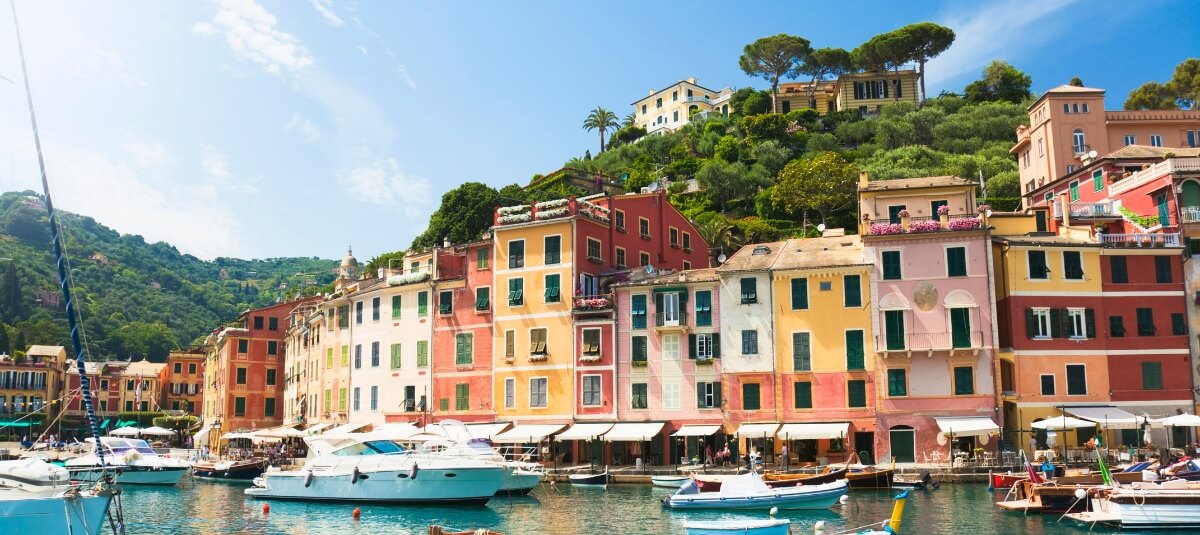 Italian Riviera harbour village with colourful waterfront homes and boats