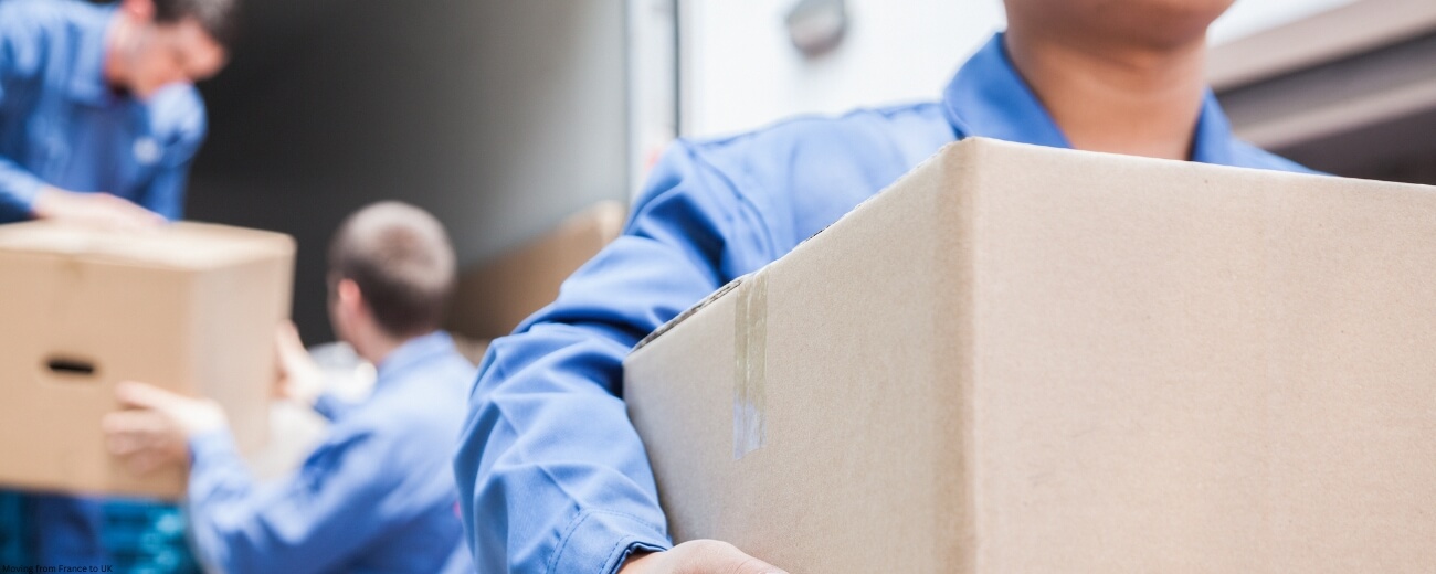 International removals team carrying boxes for customs-checked move to UK