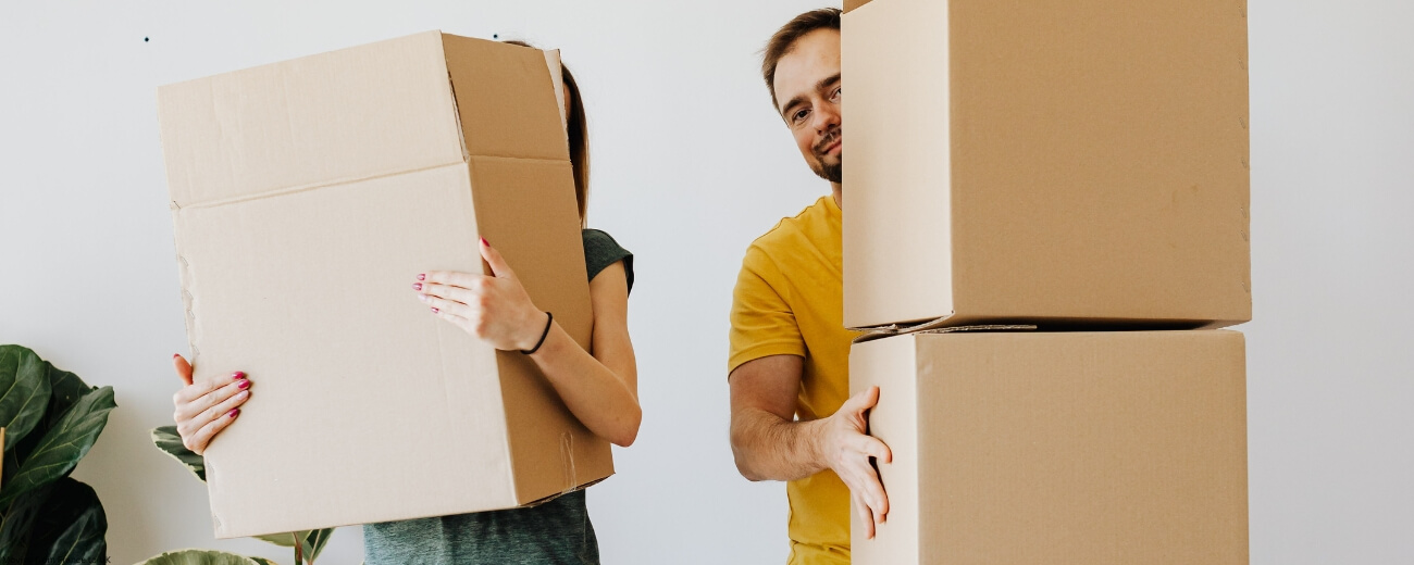 Young couple handling moving boxes during relocation to England