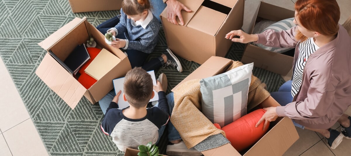 British family unpacking moving boxes in their new French home. British family unpacking moving boxes in their new French home.