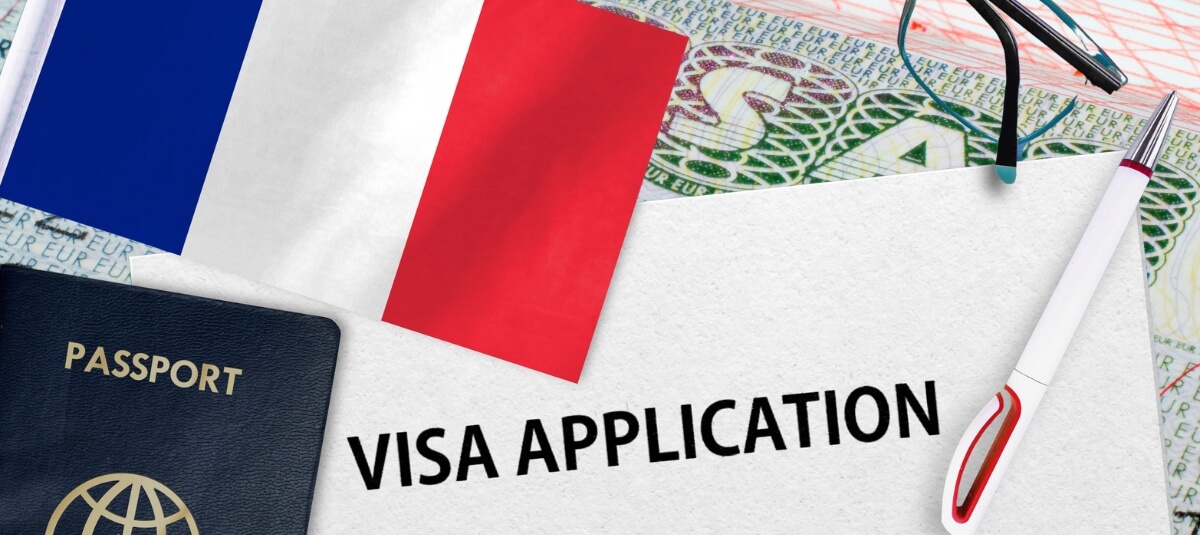 French visa application form with passport and flag representing post-Brexit move from the UK to France. French visa application form with passport and flag representing post-Brexit move from the UK to France.