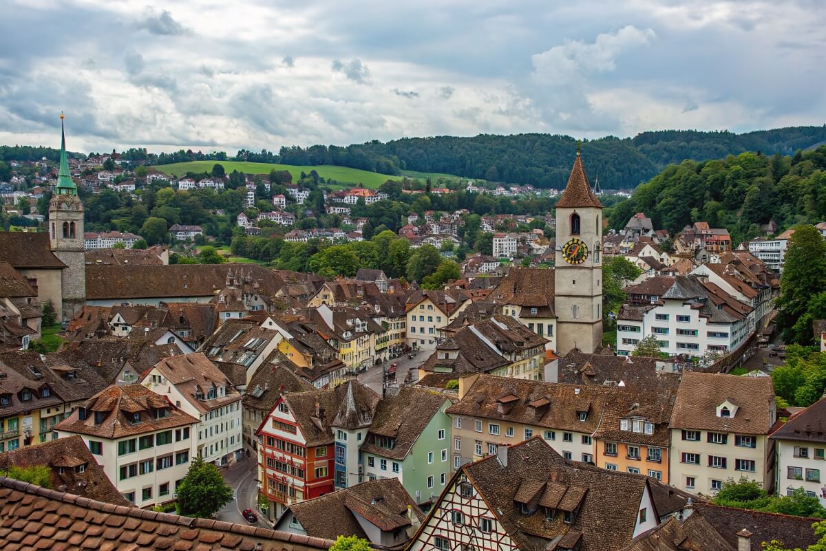 Aerial view of Schaffhausen’s Old Town with traditional Swiss rooftops, clock towers and surrounding green hills