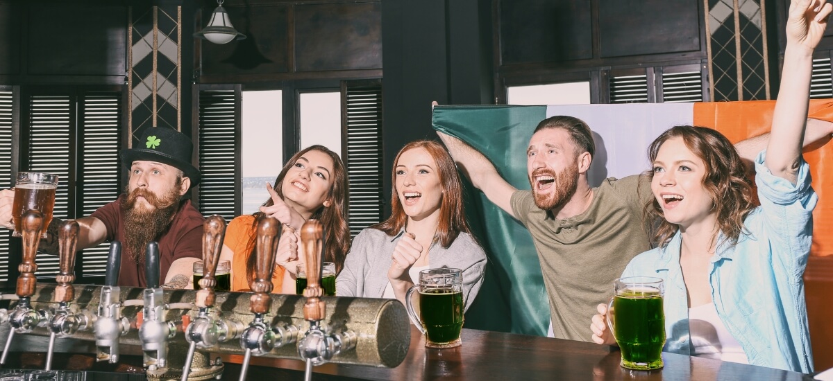 A group of friends in an Irish pub enjoying drinks and camaraderie, symbolising the warm hospitality and welcoming nature of Irish culture. A group of friends in an Irish pub enjoying drinks and camaraderie, symbolising the warm hospitality and welcoming nature of Irish culture.