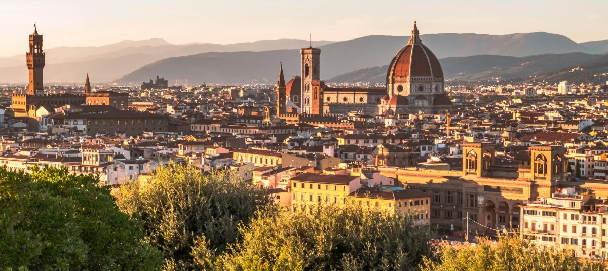 Florence skyline and Tuscan hills, showing the appeal of living in Italy
