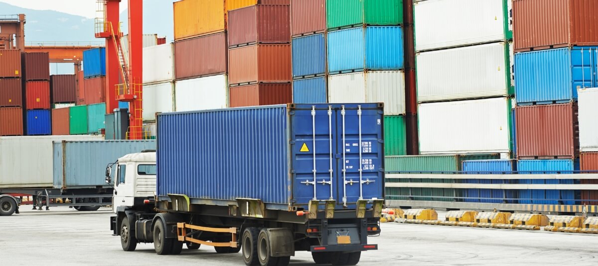 Lorry transporting a shipping container as part of a door-to-port overseas removals service from the UK. Lorry transporting a shipping container as part of a door-to-port overseas removals service from the UK.