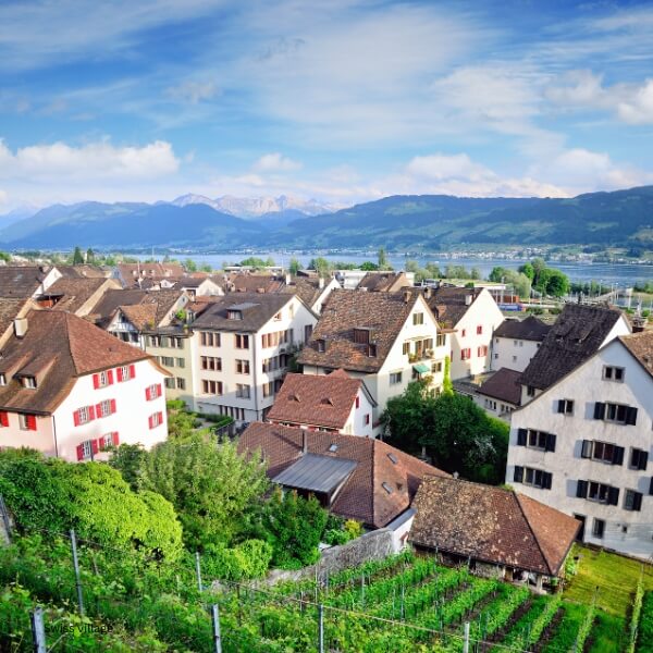 Traditional Swiss village with lake and mountain views, ideal for peaceful rural living