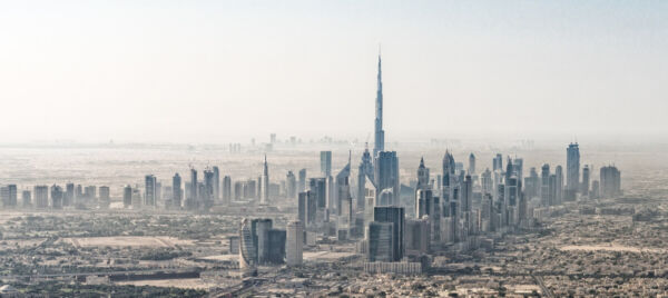 Panoramic view of Dubai skyline featuring the Burj Khalifa surrounded by modern skyscrapers, highlighting the allure of moving to the UAE for expats seeking a luxurious and dynamic lifestyle.