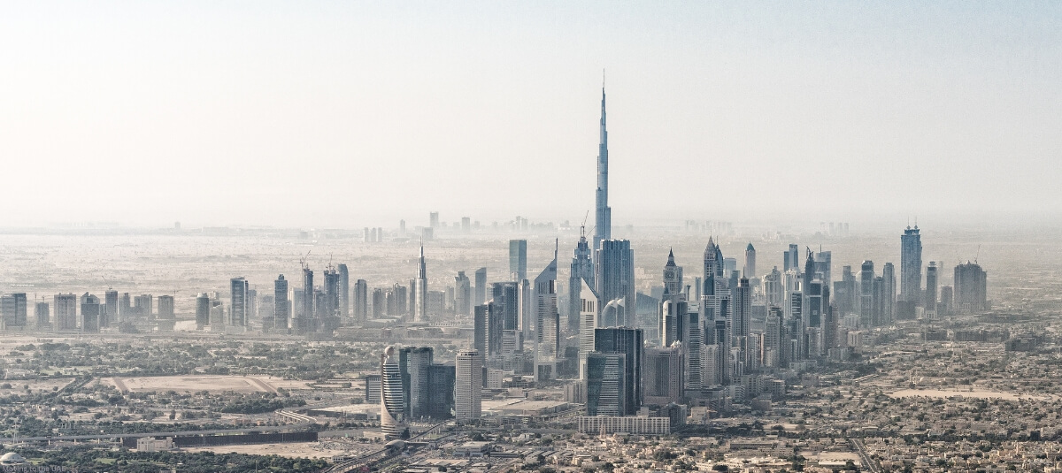 Panoramic view of Dubai skyline featuring the Burj Khalifa surrounded by modern skyscrapers, highlighting the allure of moving to the UAE for expats seeking a luxurious and dynamic lifestyle.