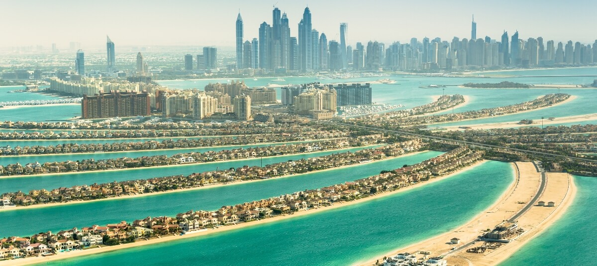 Aerial view of Palm Jumeirah, the iconic man-made island in Dubai. Aerial view of Palm Jumeirah, the iconic man-made island in Dubai.