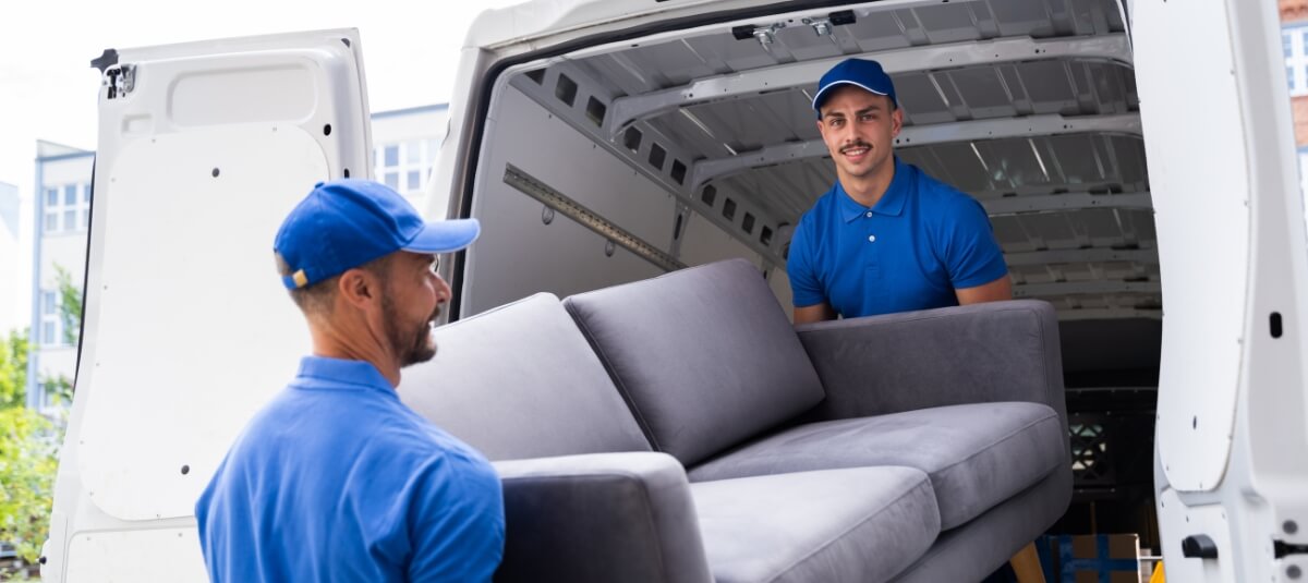 Professional movers loading furniture into a van for a UK to France relocation. Professional movers loading furniture into a van for a UK to France relocation.