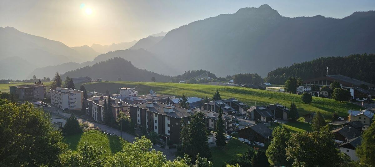 Sunset over a Swiss Alpine village surrounded by mountains, illustrating the peaceful outdoor lifestyle available to UK expats moving to Switzerland. Sunset over a Swiss Alpine village surrounded by mountains, illustrating the peaceful outdoor lifestyle available to UK expats moving to Switzerland.