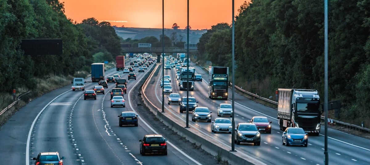 Busy UK motorway with HGV vehicles representing national long distance moving logistics.
