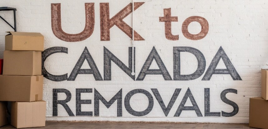 Wall with the text 'UK to Canada Removals' alongside stacked cardboard boxes, symbolizing international moving services.