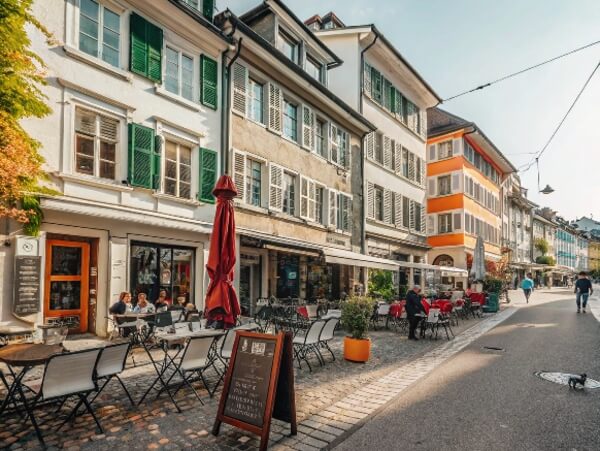 Charming pedestrian street in Winterthur city centre with colourful buildings and restaurants, ideal for expats. Charming pedestrian street in Winterthur city centre with colourful buildings and restaurants, ideal for expats.